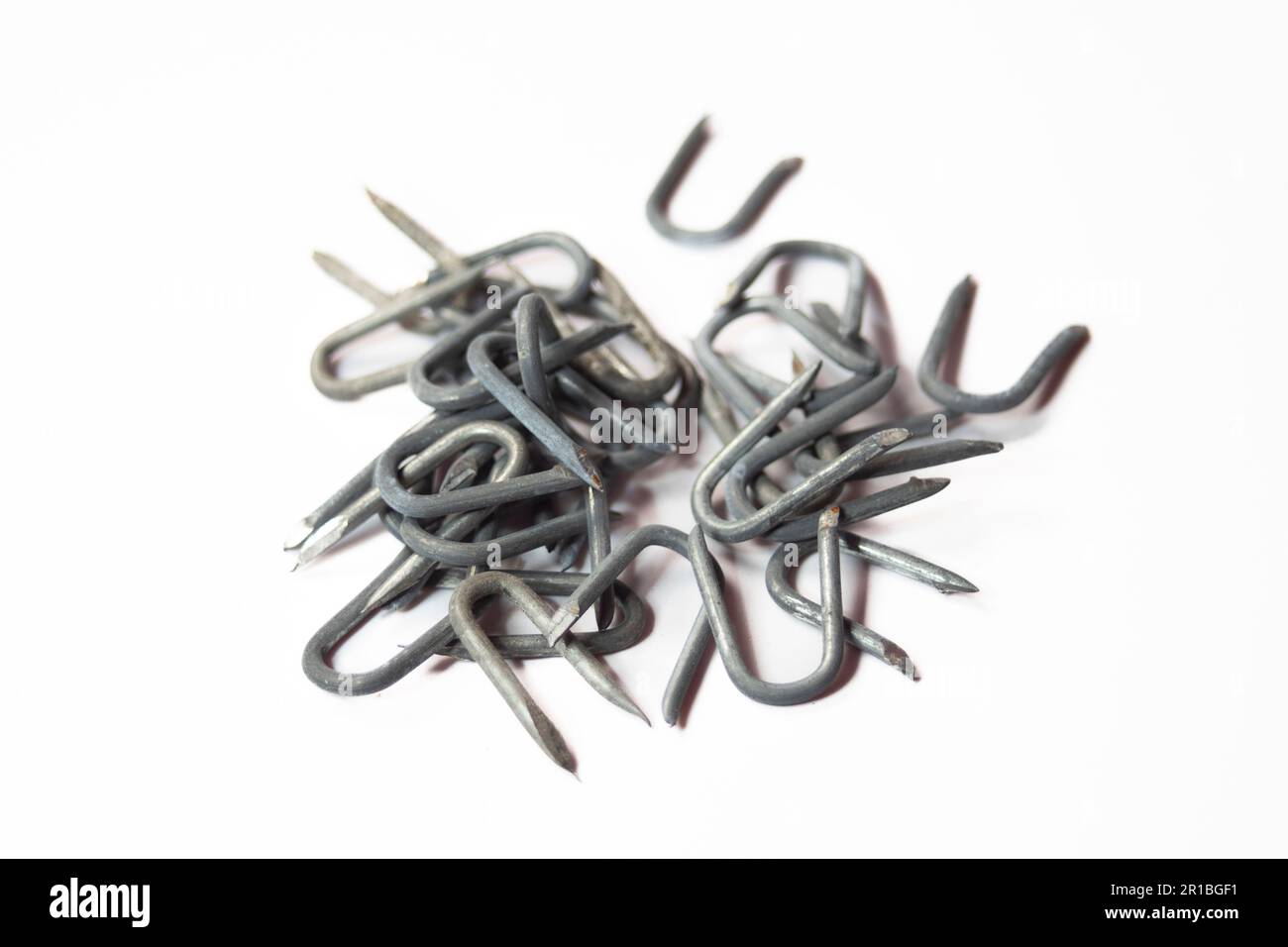 pile of heavy barbed wire staples for construction and carpentry Stock