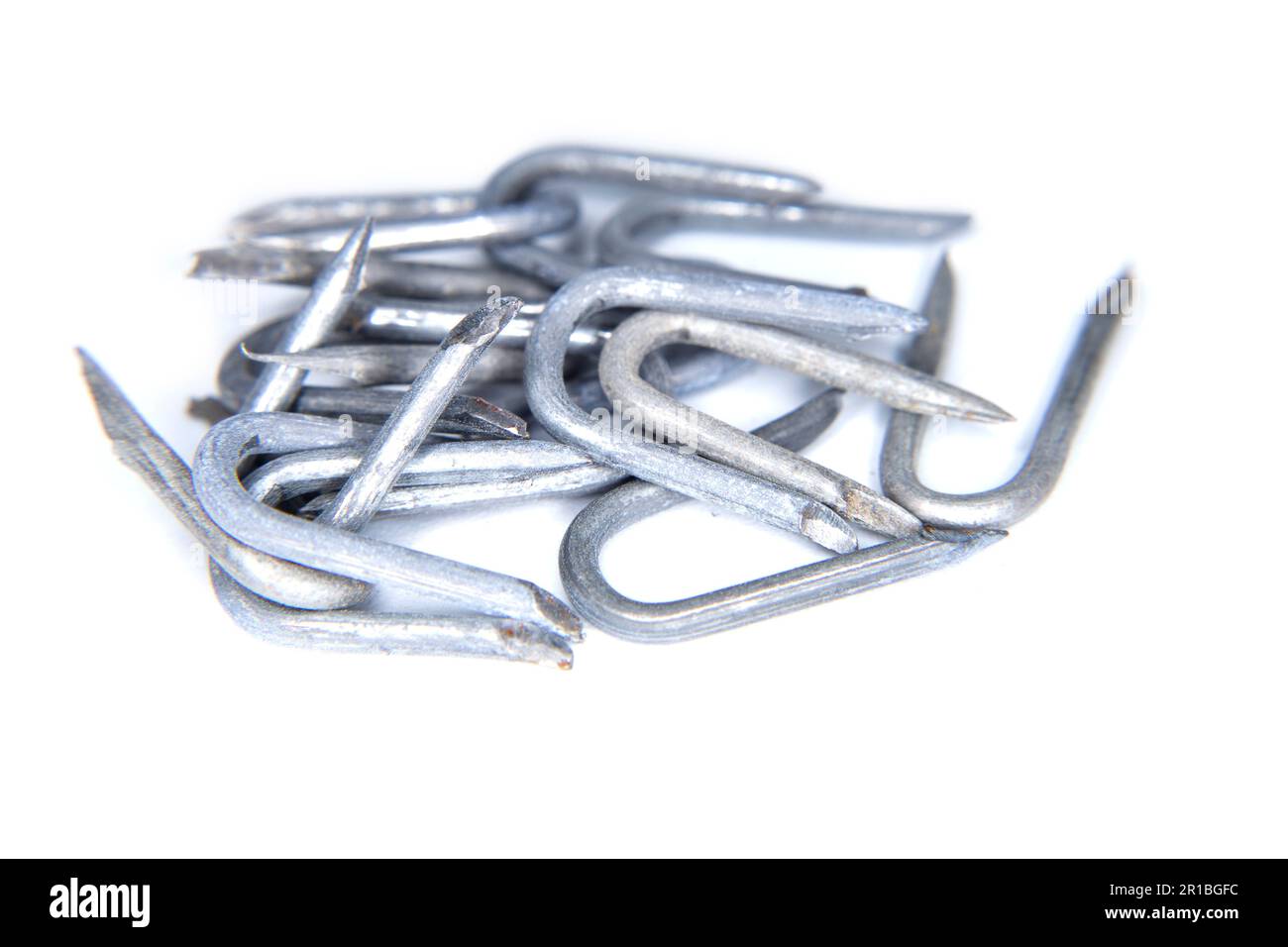 pile of heavy barbed wire staples for construction and carpentry Stock