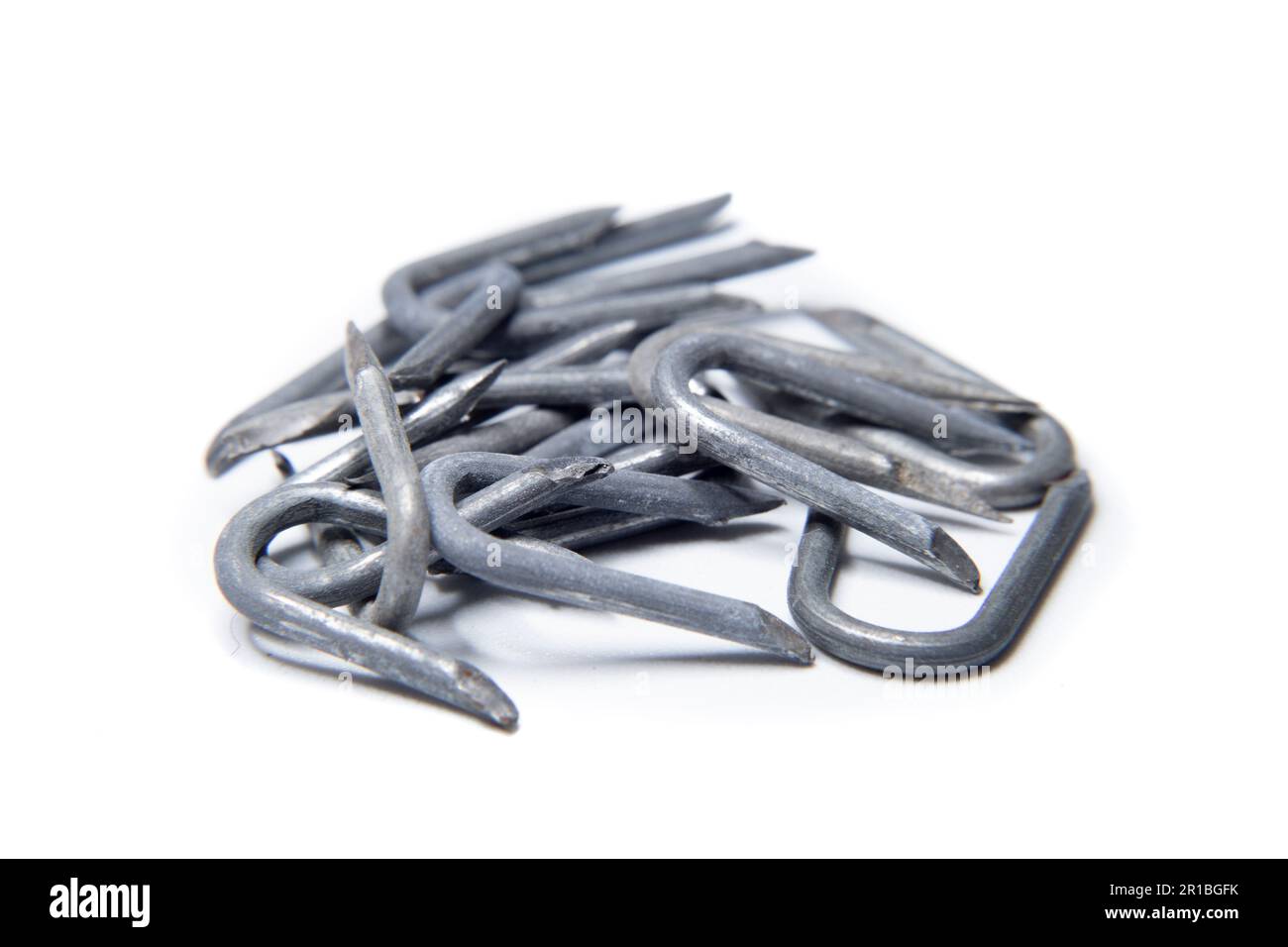 pile of heavy barbed wire staples for construction and carpentry Stock