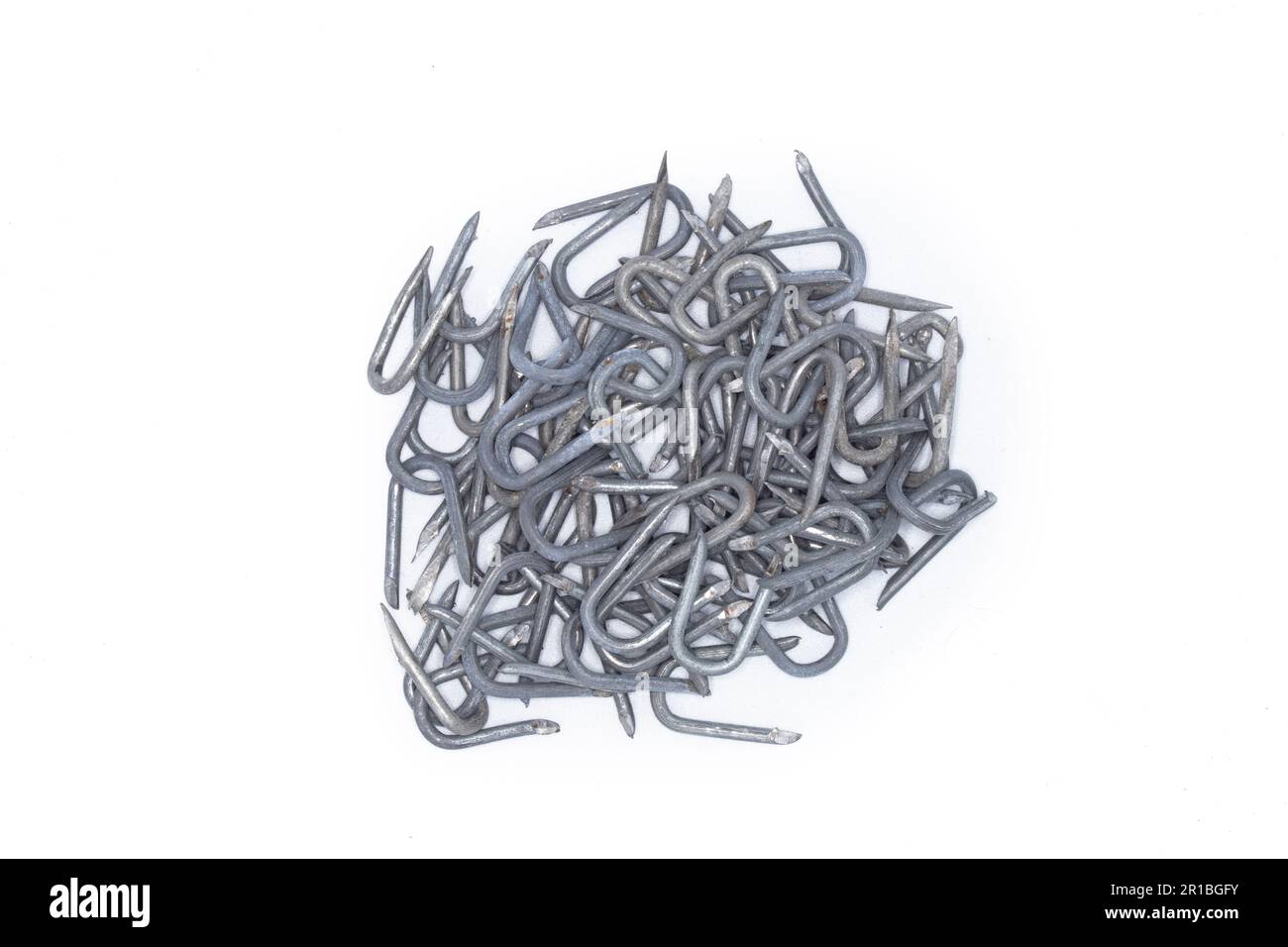 pile of heavy barbed wire staples for construction and carpentry Stock