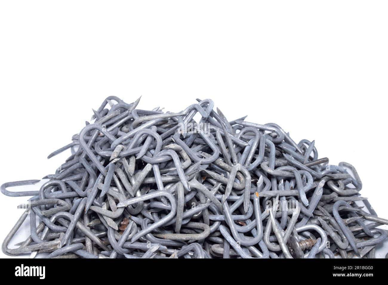 pile of heavy barbed wire staples for construction and carpentry Stock
