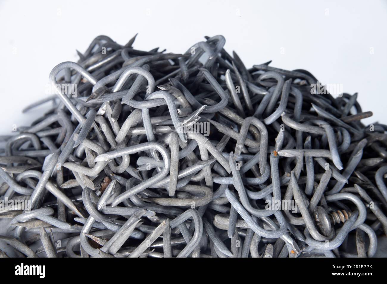 pile of heavy barbed wire staples for construction and carpentry Stock