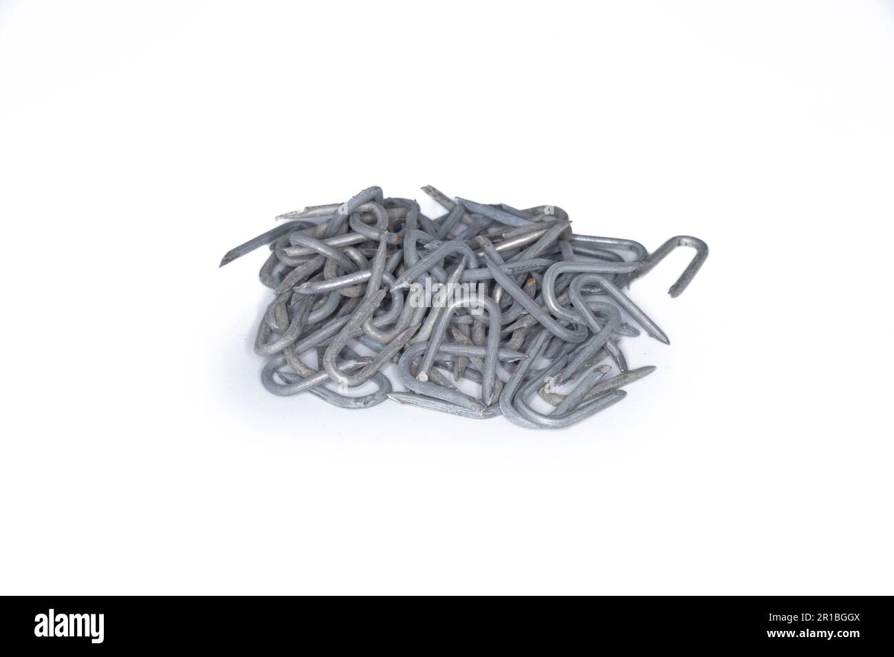 pile of heavy barbed wire staples for construction and carpentry Stock