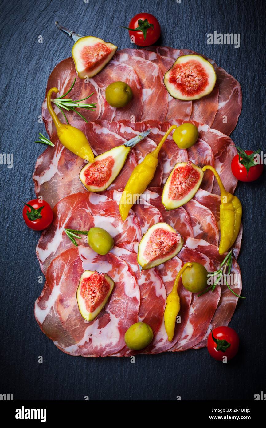 Meat catering platter with olives, hot peppers and figs Stock Photo Alamy