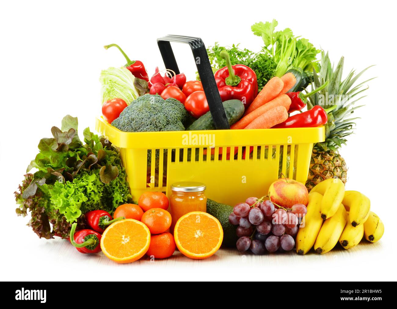Plastic shopping basket with groceries isolated on white background