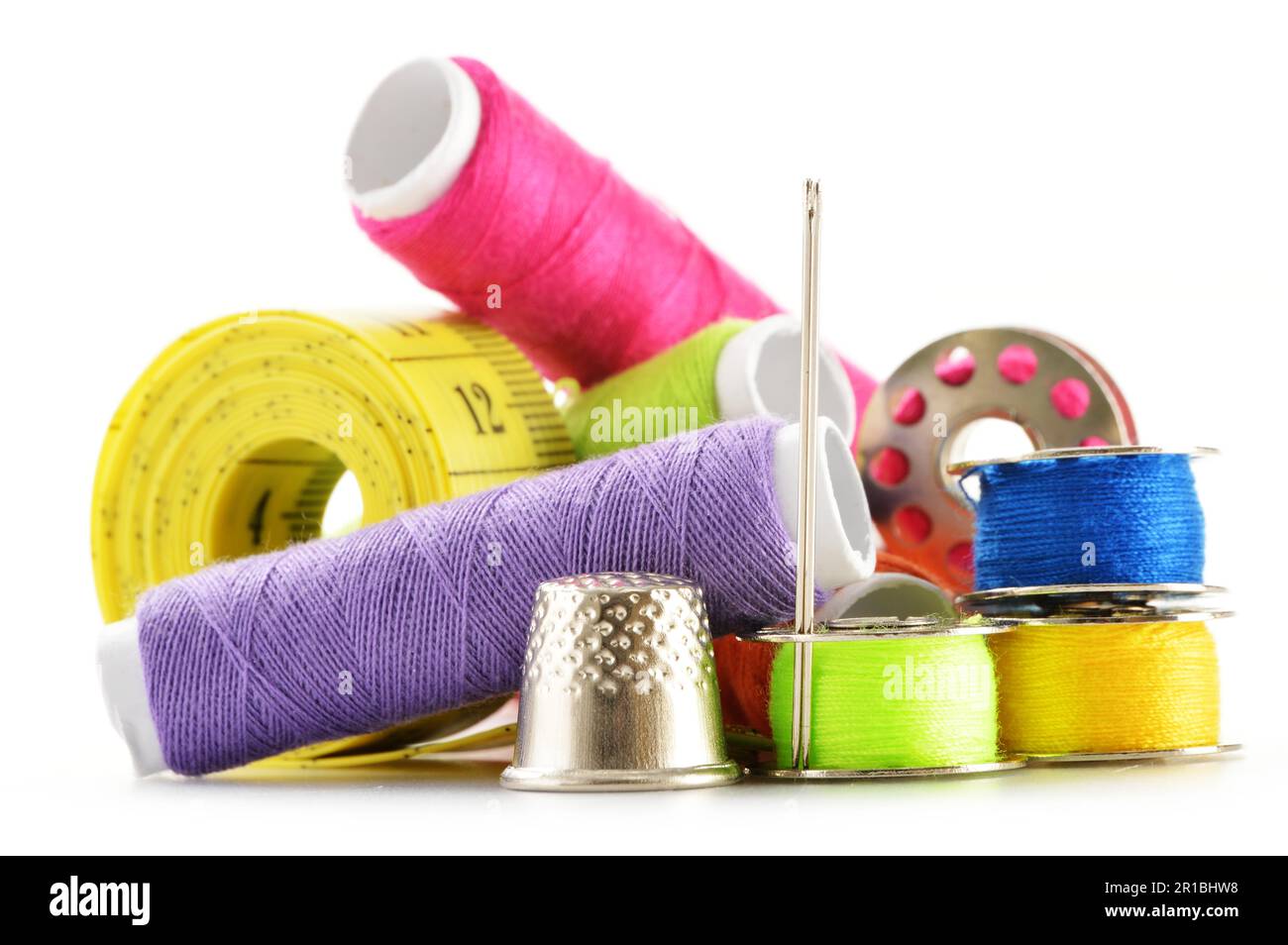 Composition with tailor needles and threads over white background Stock Photo