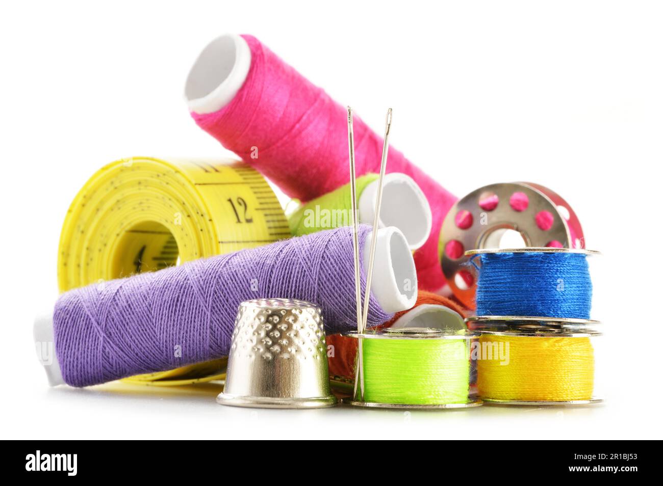 Composition with tailor needles and threads over white background Stock Photo