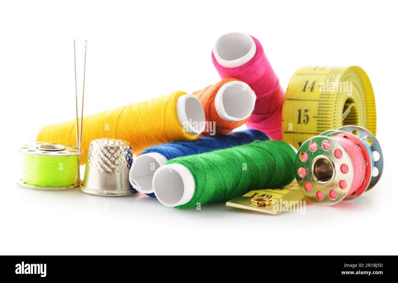 Composition with tailor needles and threads over white background Stock Photo