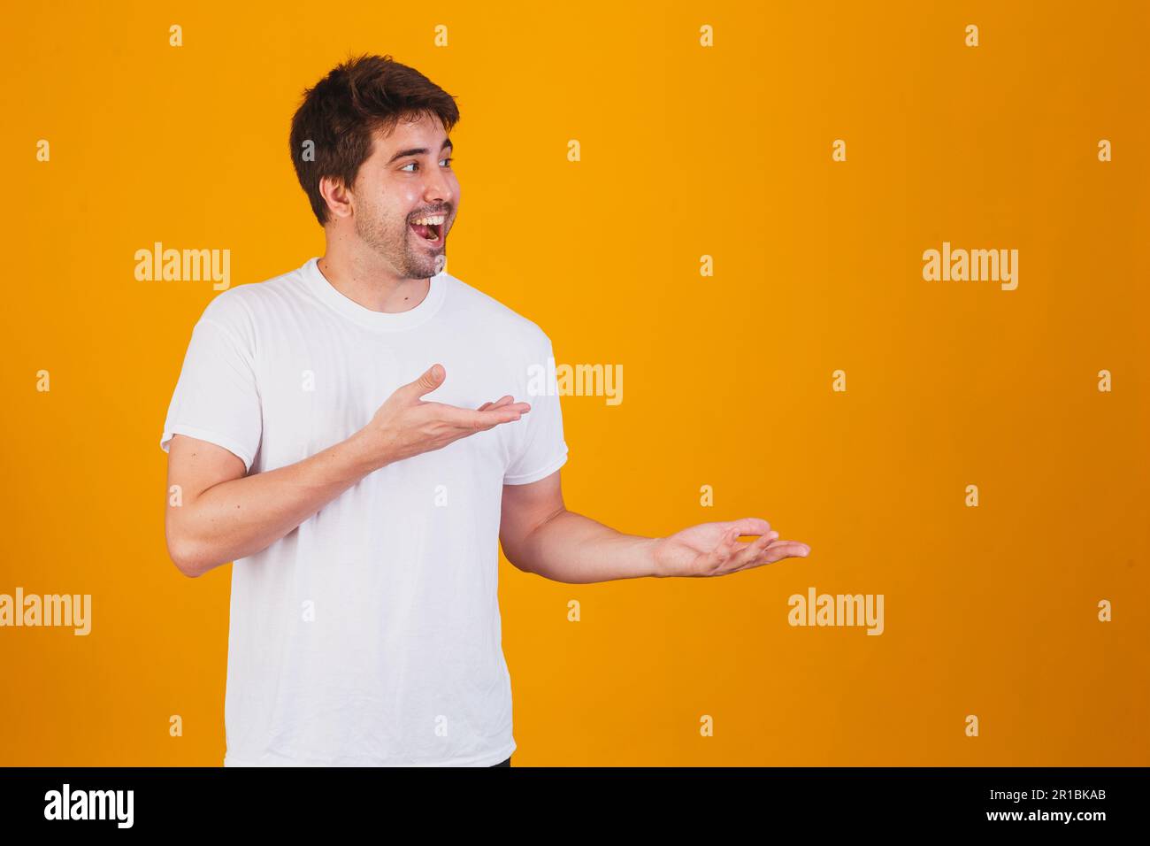 handsome man pointing to the side with space for text Stock Photo