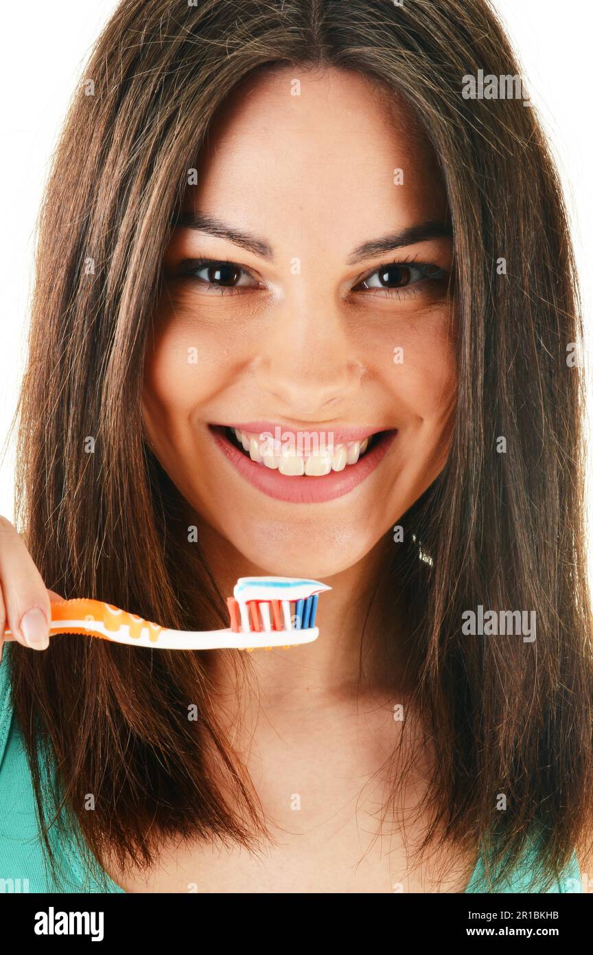 Young woman with toothbrush cleaning her teeth Stock Photo