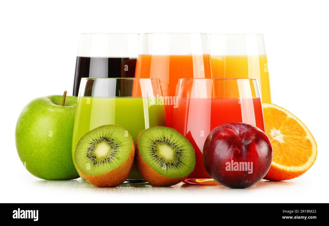 Isolated juices. Glasses of fresh juice and pile of tropical fruits  isolated on white background with clipping path Stock Photo - Alamy