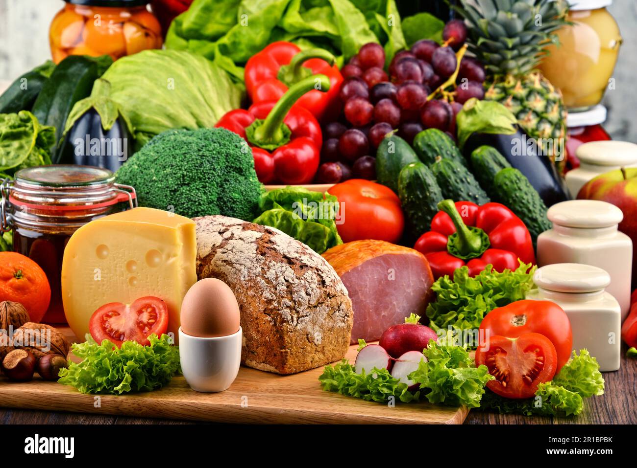 Variety of organic food including vegetables fruit bread dairy and meat ...