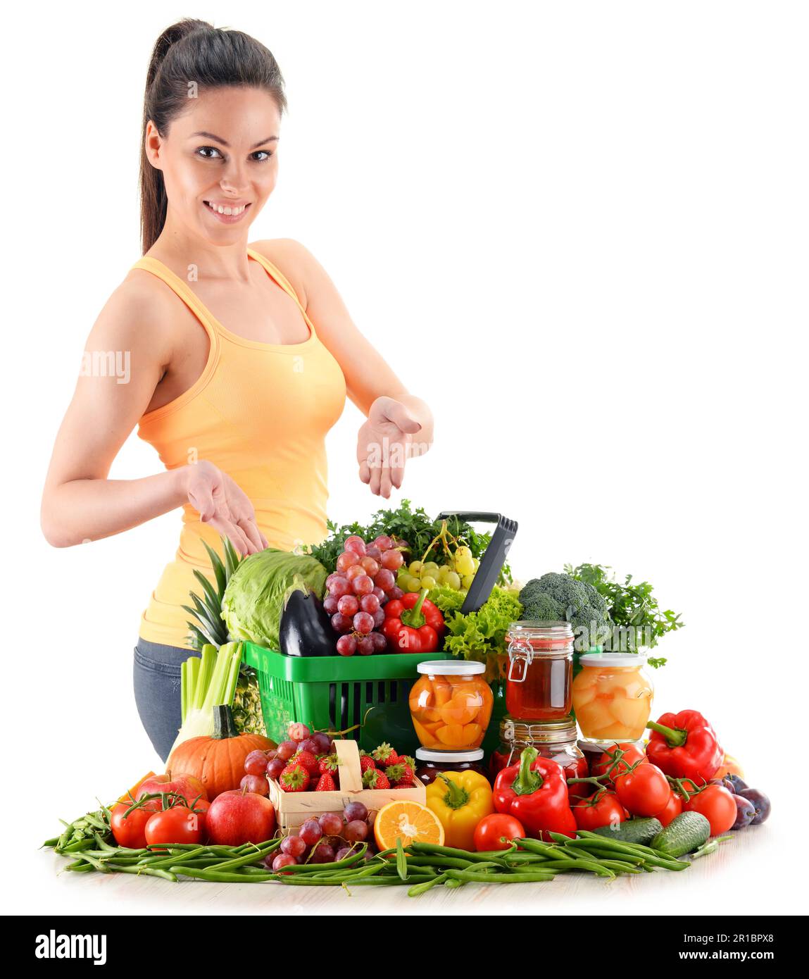Young woman with variety of organic vegetables and fruits isolated on ...
