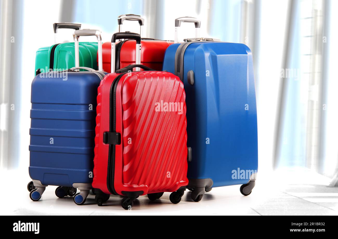 Five plastic suitcases isolated on white Stock Photo Alamy