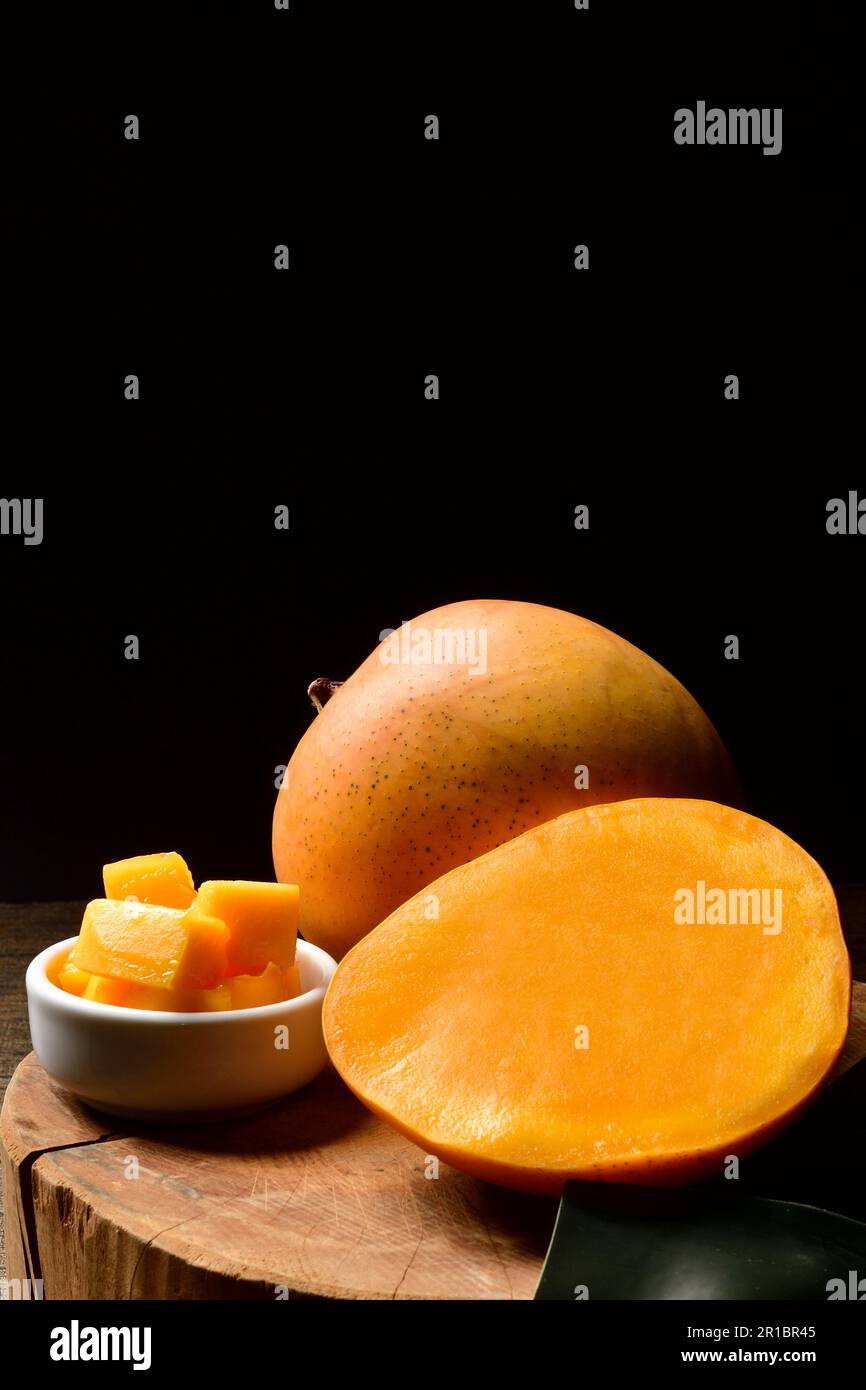 mango and mango slice with cubes on Black background.Thai Mangoes.Thai Fruit.Copy text.Copy Space. Stock Photo