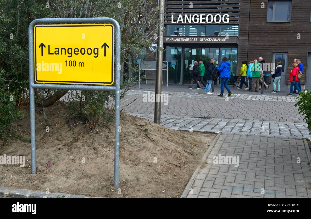 Place-name sign with the inscription Langeoog 100 m in front of the ferry house in Bensersiel, Lower Saxony, Germany Stock Photo