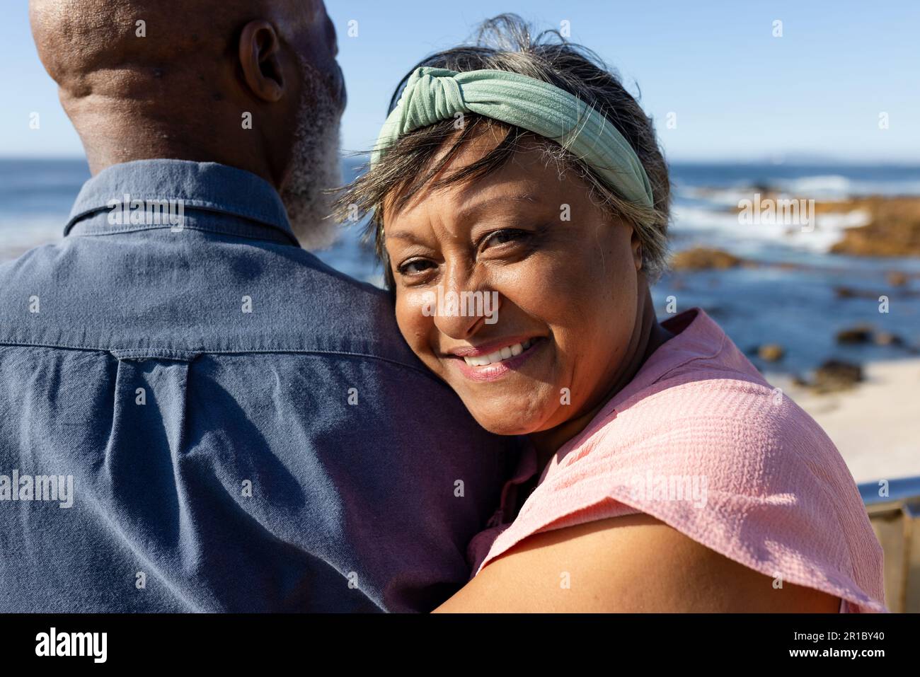 Portrait of happy senior african american couple embracing on promenade ...