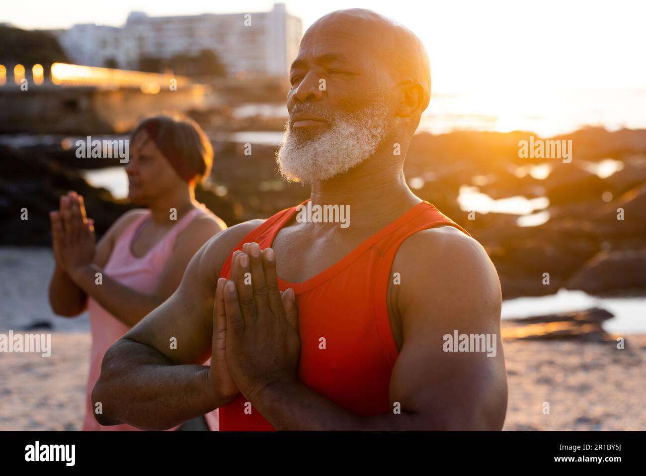 Happy senior african american couple practicing yoga and doing poses at ...