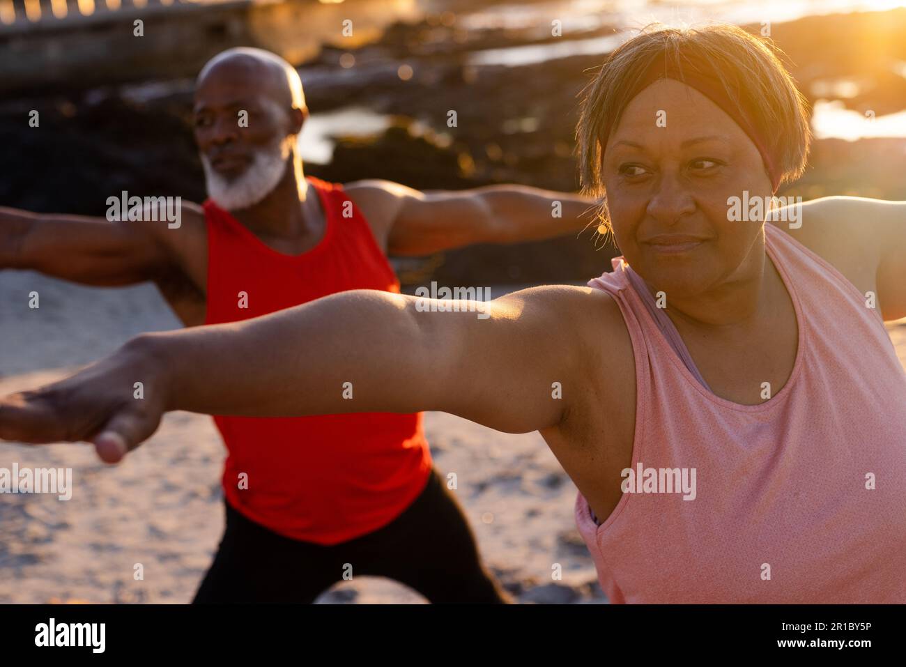 Happy senior african american couple practicing yoga and doing poses at ...