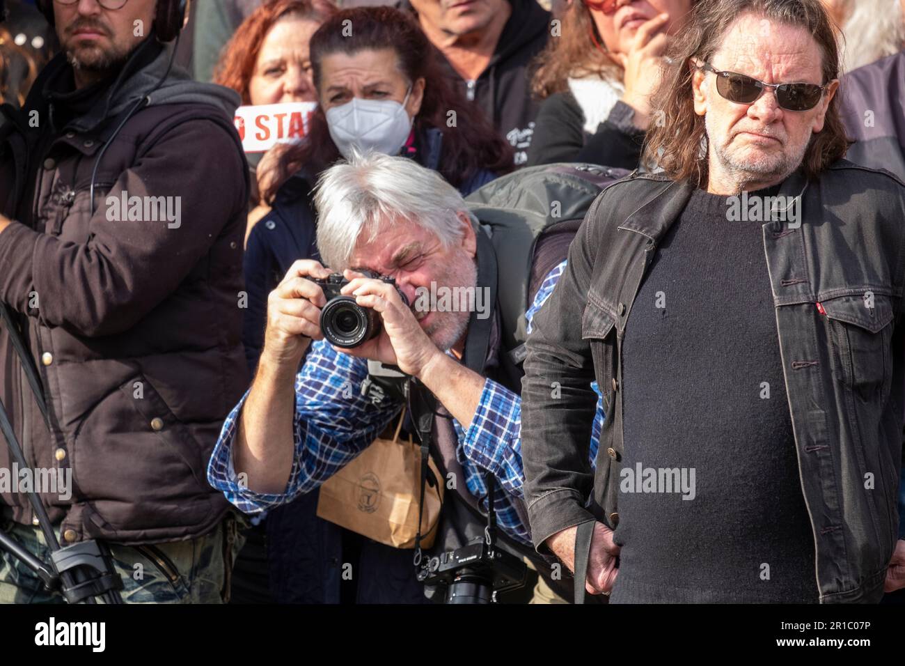 Photojournalist working in the crowd at the No Stadium Rally on ...