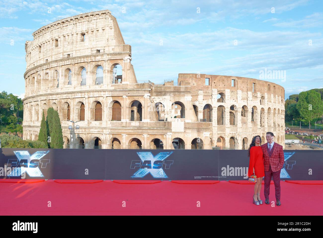 Actor John Cena with wife Shay Shariatzadeh attend the red carpet event for FAST X at the Colosseum, Rome Temple of Venus on May 24, 2023 in Rome, It Stock Photo