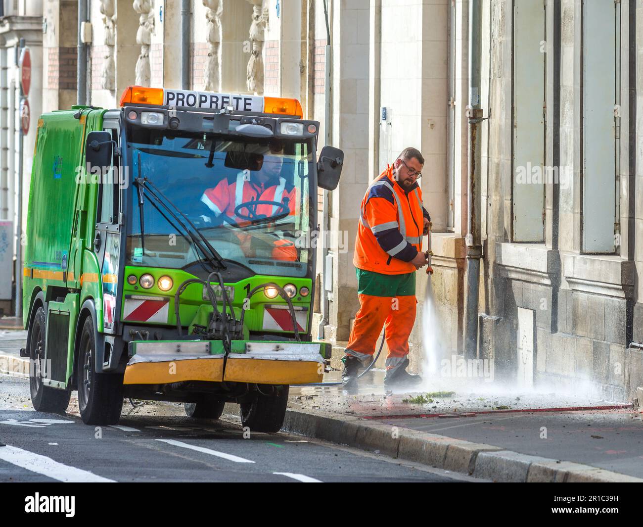 Council workers cleaning pavement with water jet, Tours, Indre-et-Loire (37), France. Stock Photo