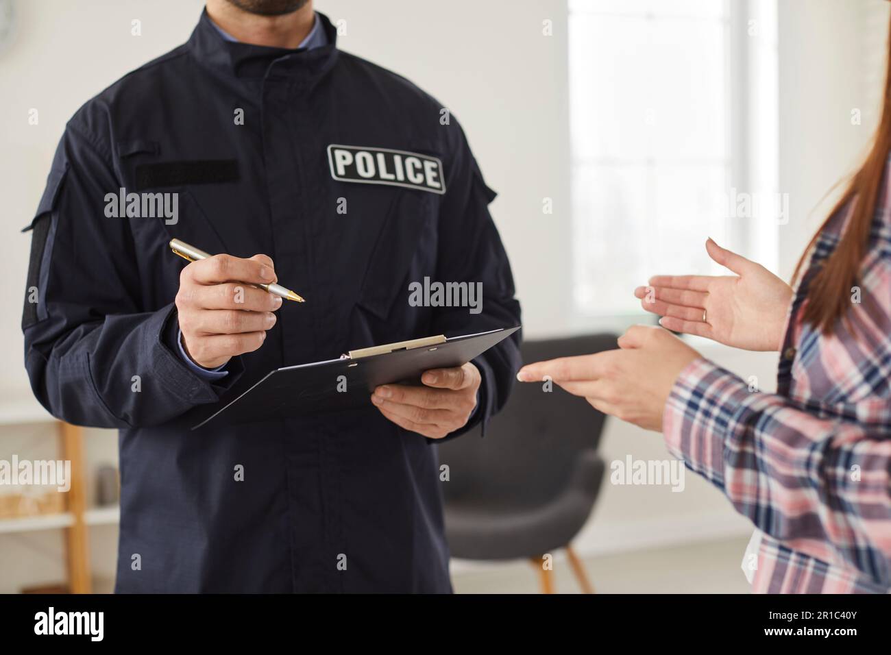 Policeman interrogating woman or witness regarding police investigation ...