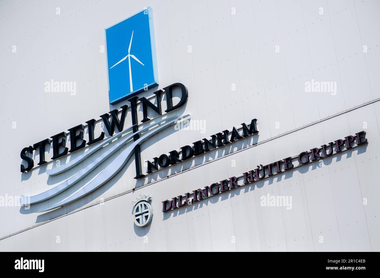 Nordenham, Germany. 12th May, 2023. The logo of Steelwind Nordenham GmbH hangs on a production hall. The company on the Weser produces steel foundations, so-called monopiles, which are used for wind turbines in offshore wind farms. Credit: Hauke-Christian Dittrich/dpa/Alamy Live News Stock Photo