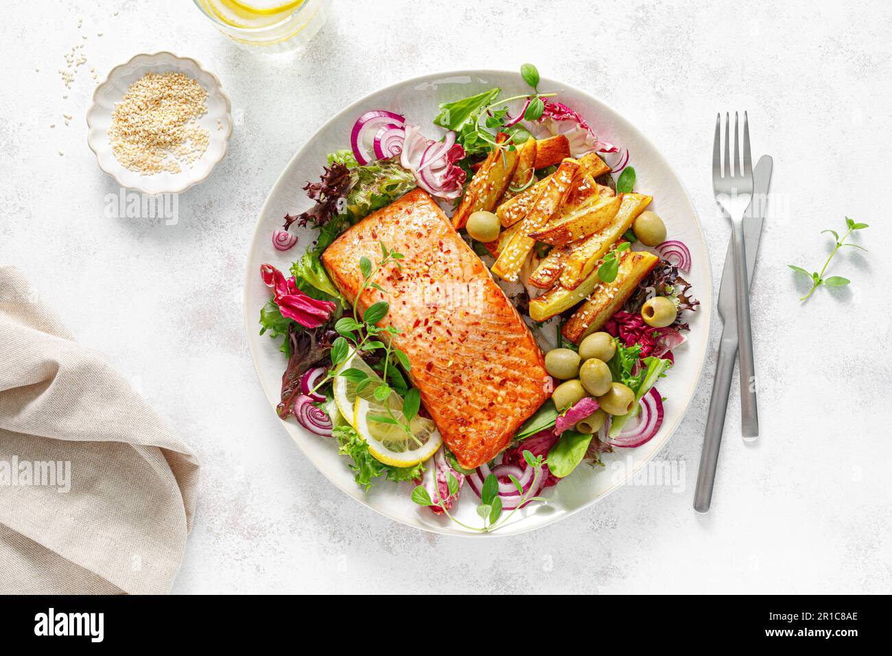 Salmon fillet grilled, fried potato and fresh vegetable green salad, top view Stock Photo