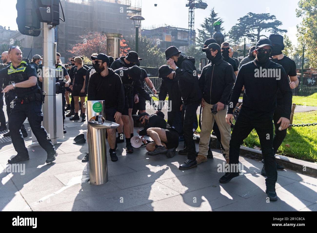 Melbourne, Australia, May 13th 2023. NSN Melbourne leader Thomas Sewell collapses after being hit by a bottle, thrown by anti-fascist counter protesters. Credit: Jay Kogler/Alamy Live News Stock Photo