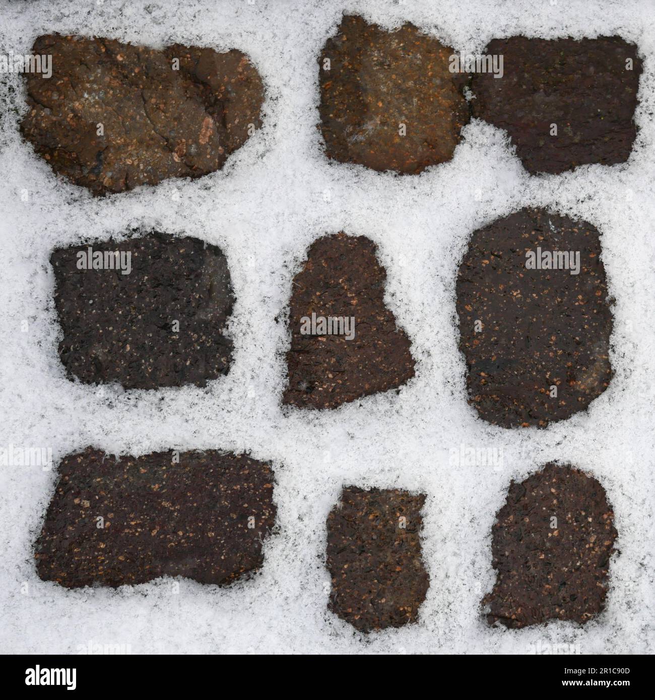 Snow filling all gaps of stones of a walkway Stock Photo Alamy