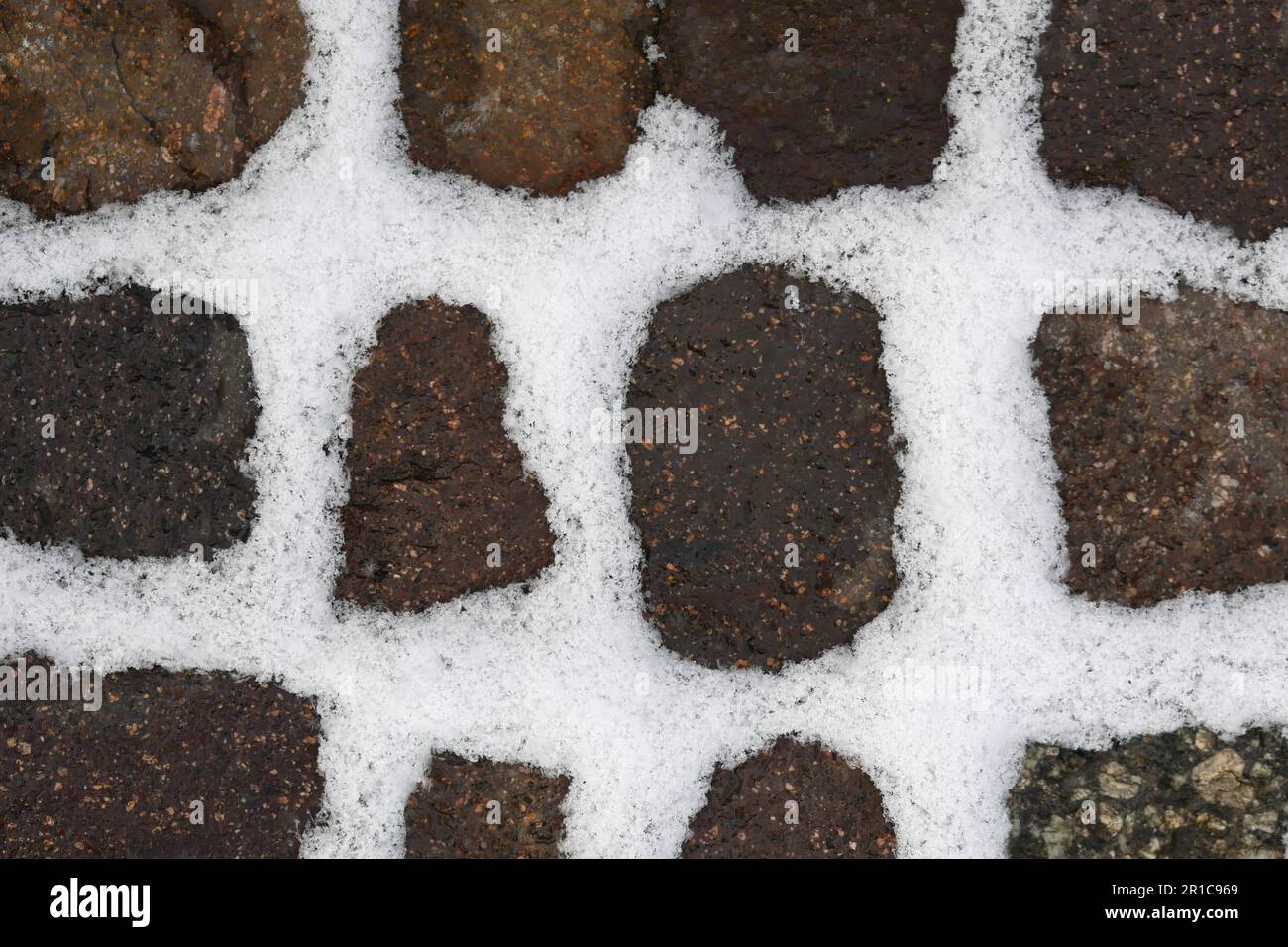 Snow filling all gaps of stones of a walkway Stock Photo Alamy