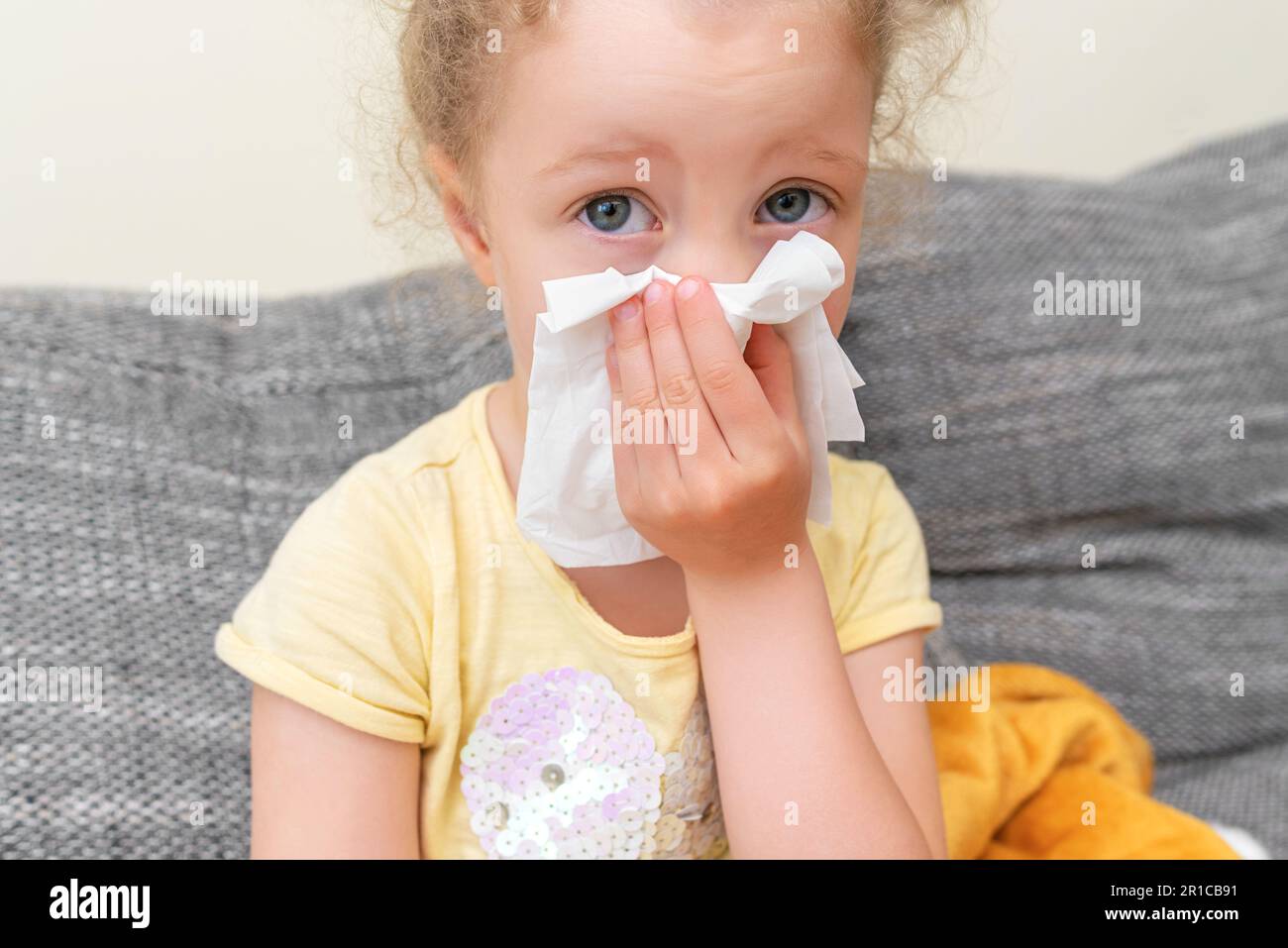 The child has a cold. He wipes his nose with a tissue Stock Photo Alamy