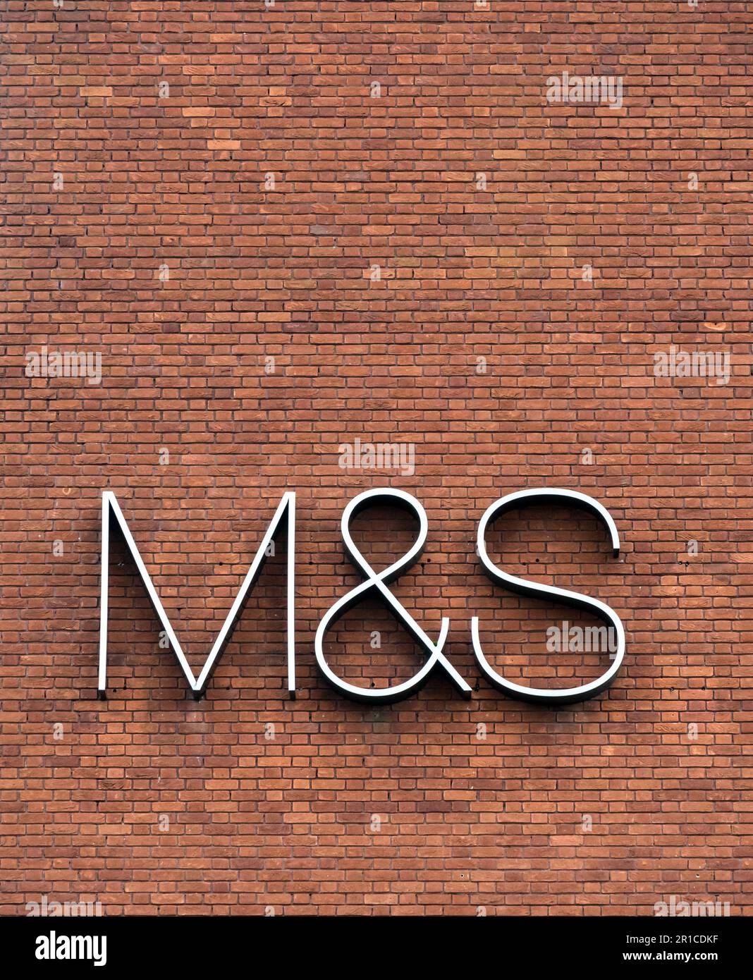 Large M&S logo on brick wall, Lincoln city 2023 Stock Photo