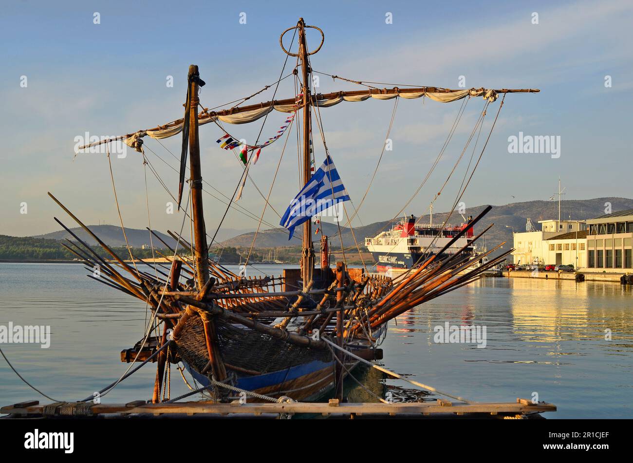Volos, Greece - October 2nd 2012: Nostalgic rowing boat - galley in the harbor of Volos, in background car ferry to Greek islands Stock Photo