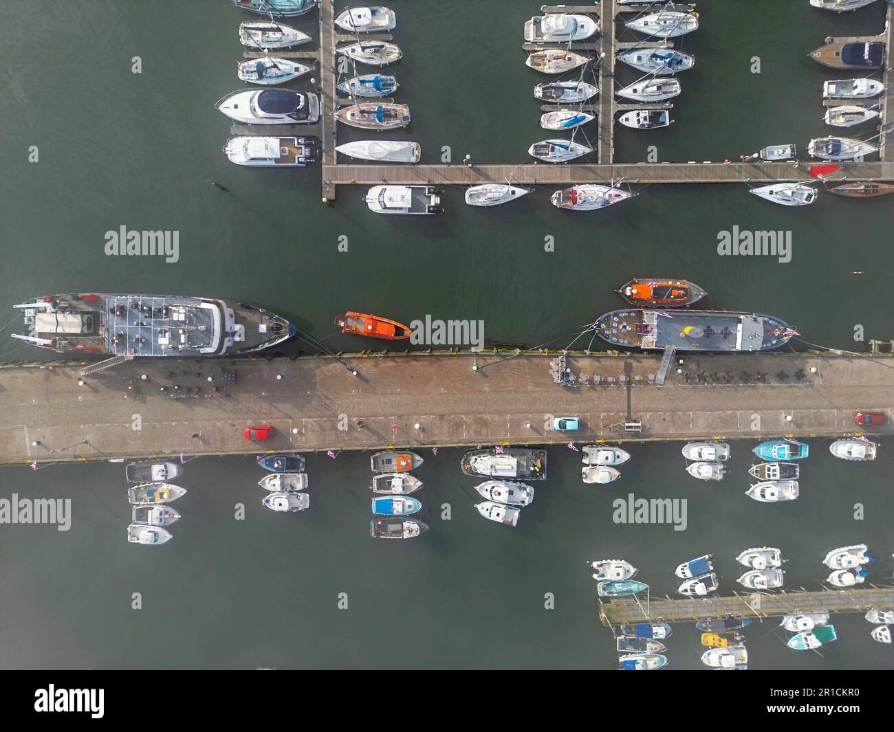An aerial view of a bustling marina with a variety of boats of various ...
