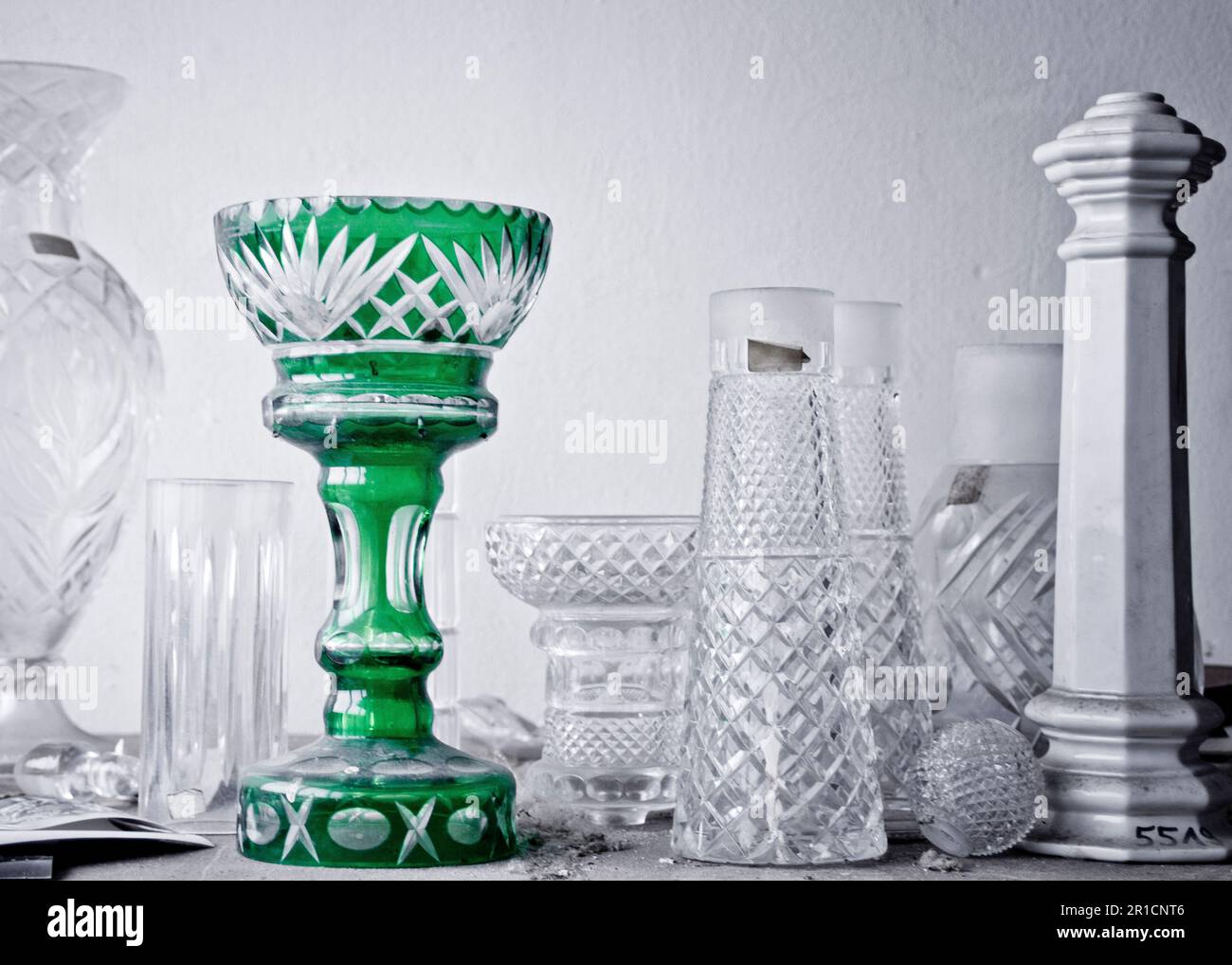 a green lead crystal vase amonst some white and clear ones Stock Photo