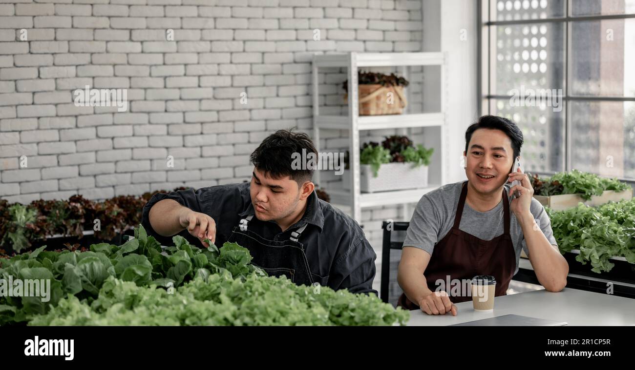 The vegetable seller celebrated with his staff on receiving a large number of orders via phone. This has the potential to generate high income and pro Stock Photo