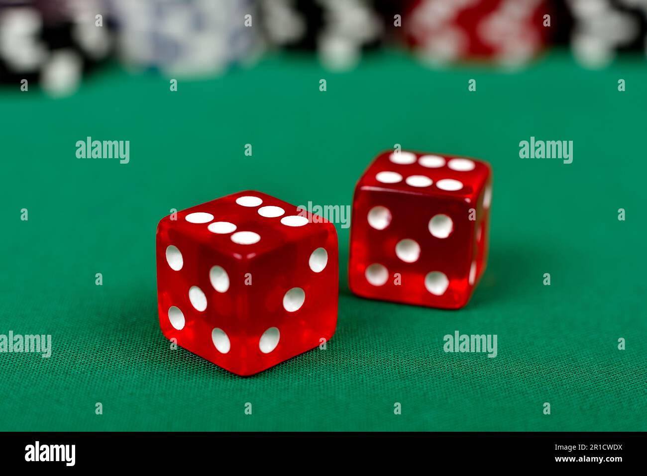 two red dice on green table Stock Photo