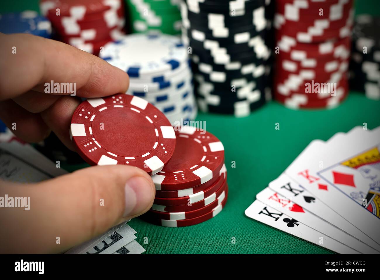 hand holding two color poker chips close up Stock Photo Alamy