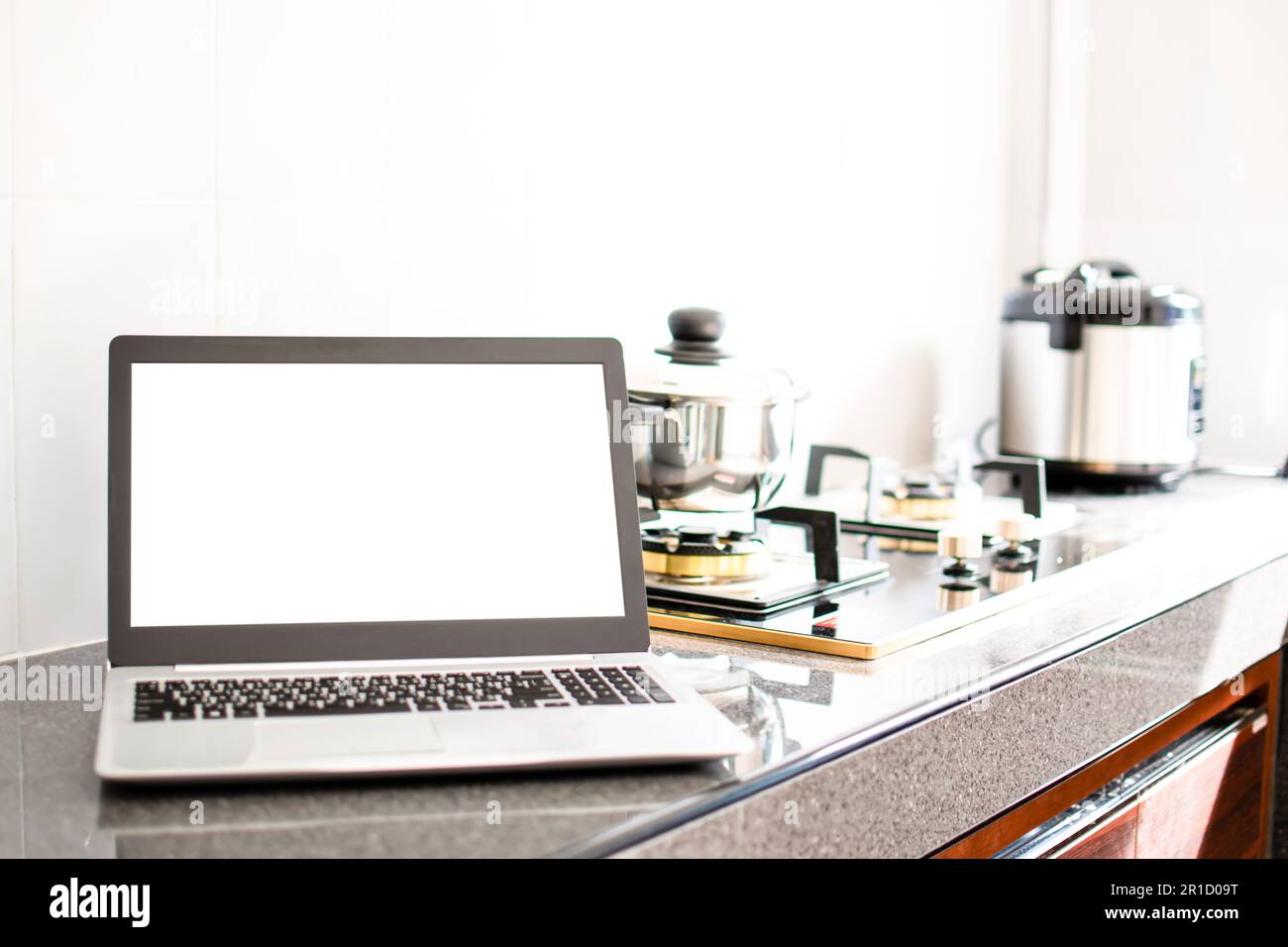 Stainless grey metal kitchen gas stove installed on a the kitchen with a  dark grey table top Stock Photo - Alamy