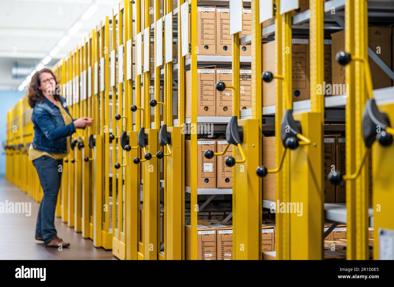 13 May 2023, Saxony, Chemnitz: An archivist opens the rolling shelving system in the storage facility of the Bundesarchiv Stasi-Unterlagen-Archiv Chemnitz. The archive at the Chemnitz site has already moved into a former industrial building at the end of 2022. The two-story low-rise building houses two storage rooms in which around seven kilometers of documents, approximately 2.3 million index cards and over 71000 photographic documents are stored. Since 1992, Chemnitz has received 329932 requests for personal file inspection; in 2022, the number was 1361. Photo: Kristin Schmidt/dpa Stock Photo