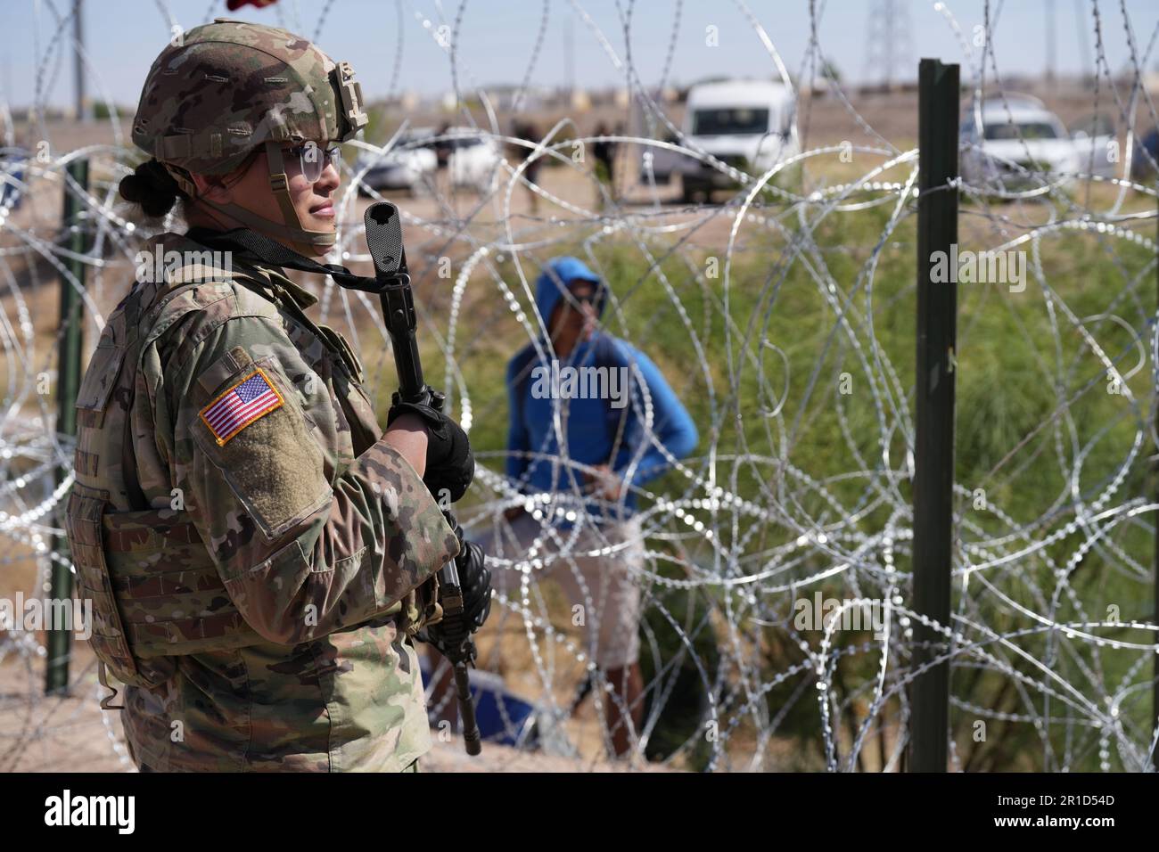 El Paso, United States. 11th May, 2023. People look across the border from Mexico at the Texas Army National Guard soldiers with the governors self-styled Texas Tactical Border Force, during Operation Lone Star Task Force West, May 11, 2023 near El Paso, Texas. The fear over a migrant surge after Title 42 expired failed to materialize with fewer migrants risking the tougher penalties under the new Title 8 rules. Credit: Mark Otte/Texas National Guard/Alamy Live News Stock Photo