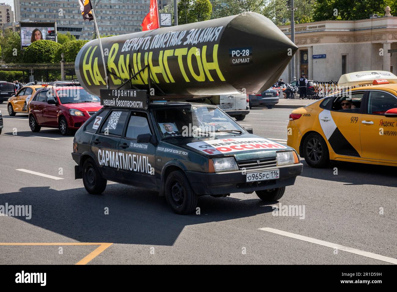 Moscow, Russia. 13th May, 2023. A vehicle with a mock Russian missile with the inscription reading 'Let's program it again to target Washington' drives on a central street in Moscow, Russia. Pro-Kremlin activist Ravil Garifullin, a resident of the city of Kazan, makes a four-month propaganda rally in his car across Russia Stock Photo