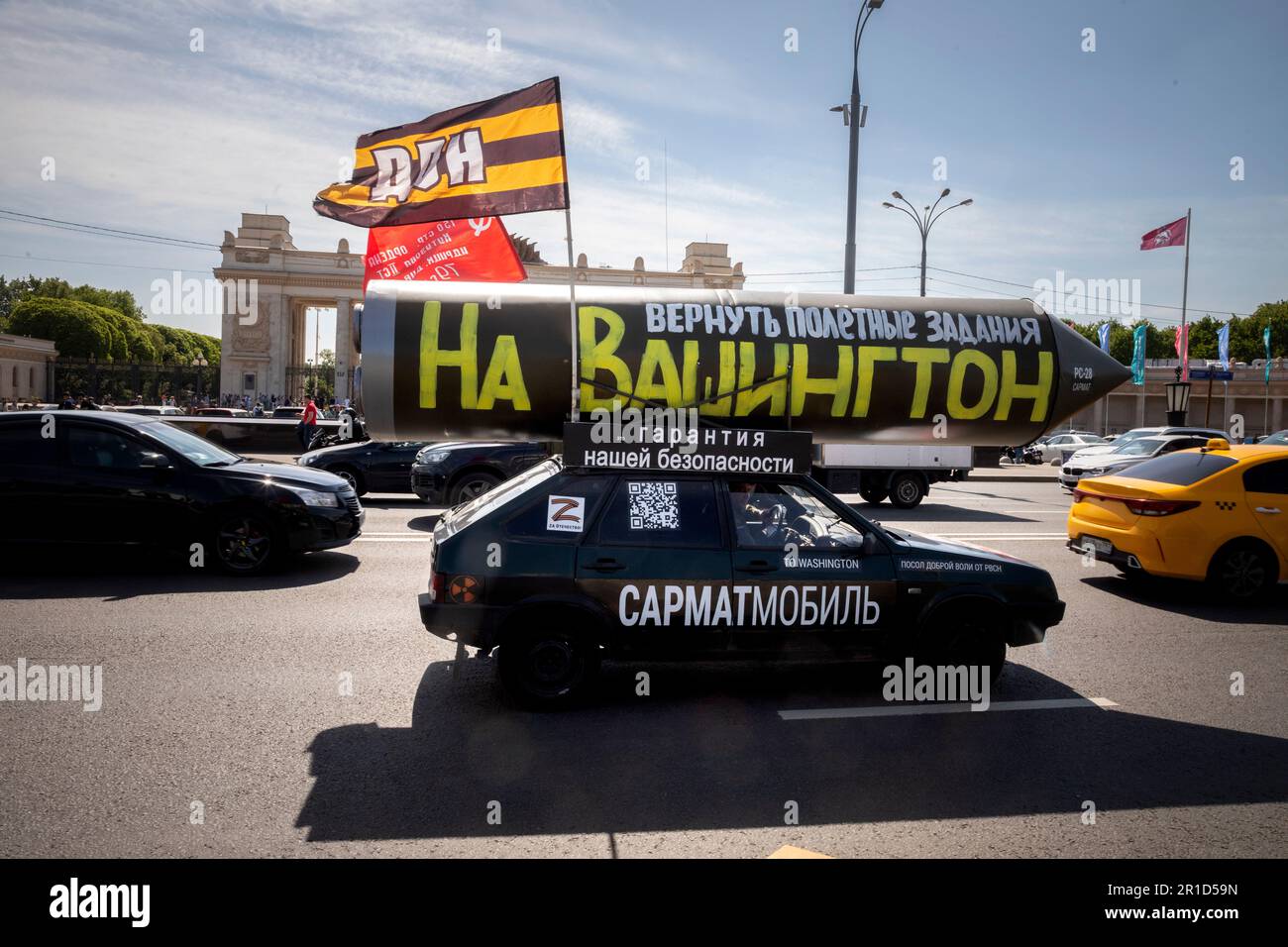 Moscow, Russia. 13th May, 2023. A vehicle with a mock Russian missile with the inscription reading 'Let's program it again to target Washington' drives on a central street in Moscow, Russia. Pro-Kremlin activist Ravil Garifullin, a resident of the city of Kazan, makes a four-month propaganda rally in his car across Russia Stock Photo