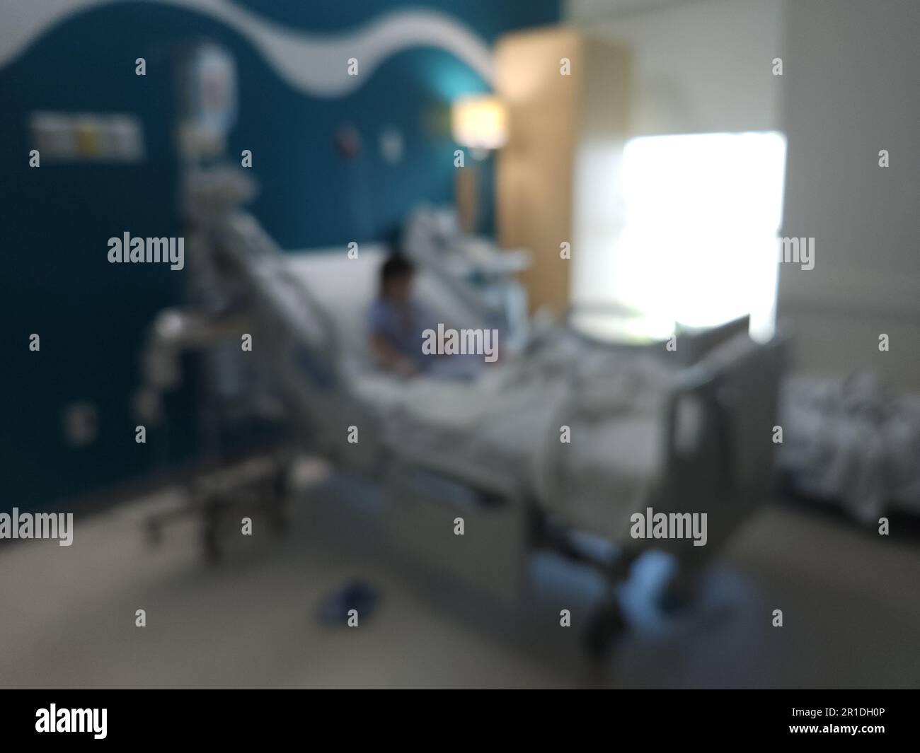 Kid in hospital bed room blurred background Stock Photo