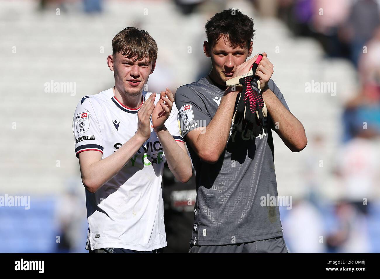 Bolton Wanderers' Conor Bradley (left) and goal keeper James Trafford applaud the fans at the end of the game of the Sky Bet League One play-off semi-final first leg match at the University of Bolton Stadium, Bolton. Picture date: Saturday May 13, 2023. Stock Photo