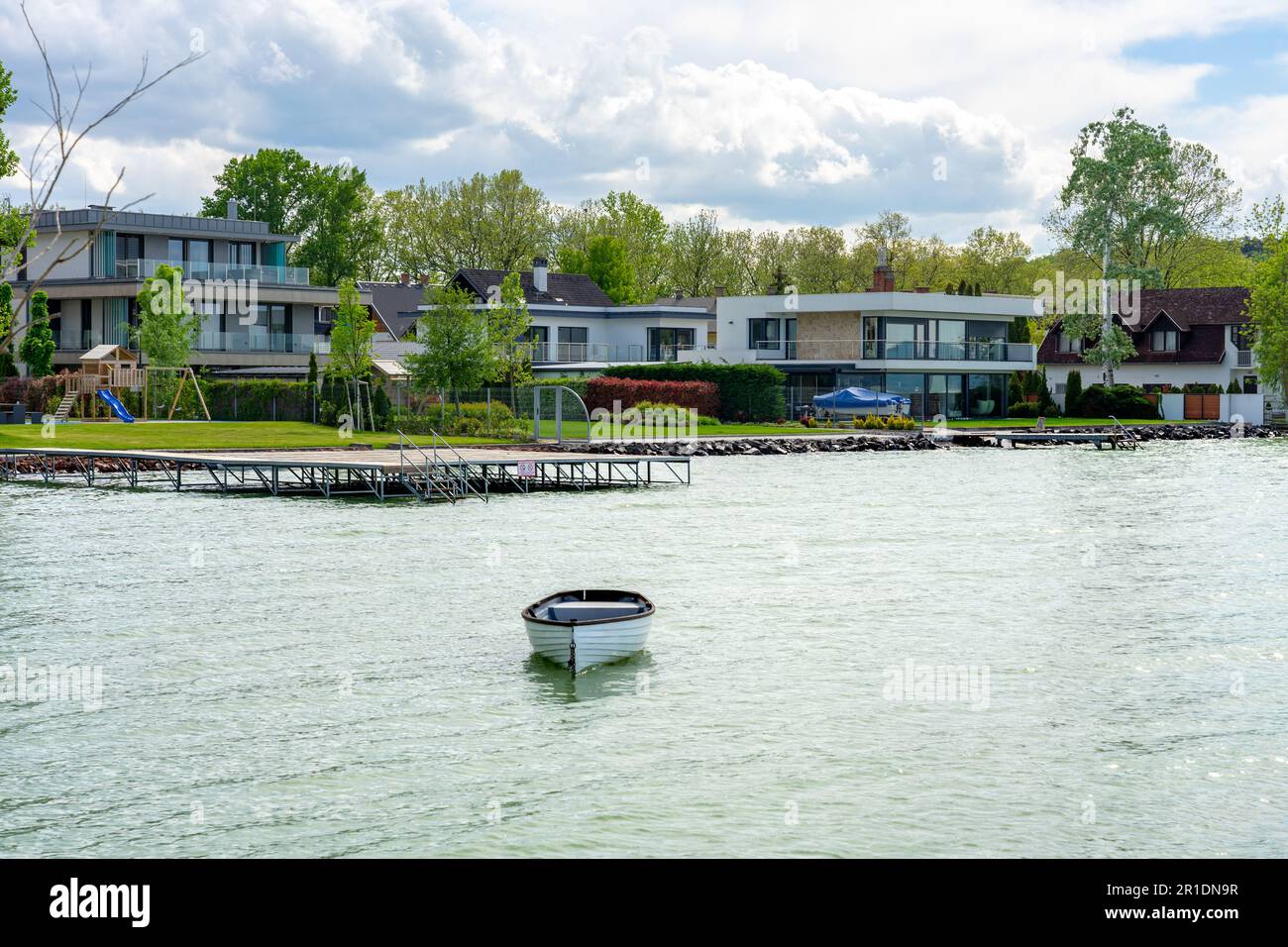 beautiful modern holiday home row next to lake Balaon with a boat . Stock Photo