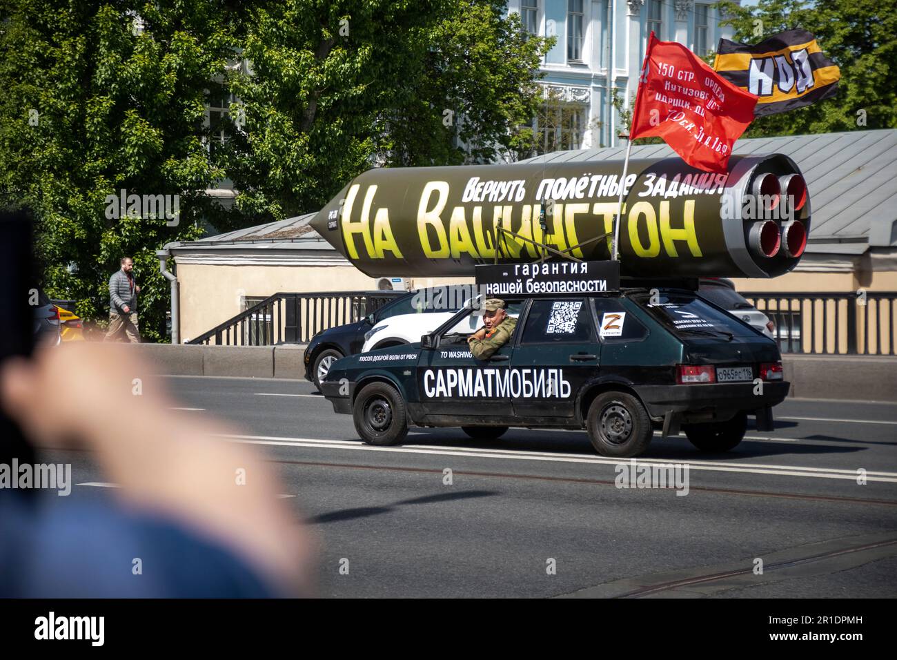 Moscow, Russia. 13th May, 2023. A vehicle with a mock Russian missile with the inscription reading 'Let's program it again to target Washington' drives on a central street in Moscow, Russia. Pro-Kremlin activist Ravil Garifullin, a resident of the city of Kazan, makes a four-month propaganda rally in his car across Russia Stock Photo