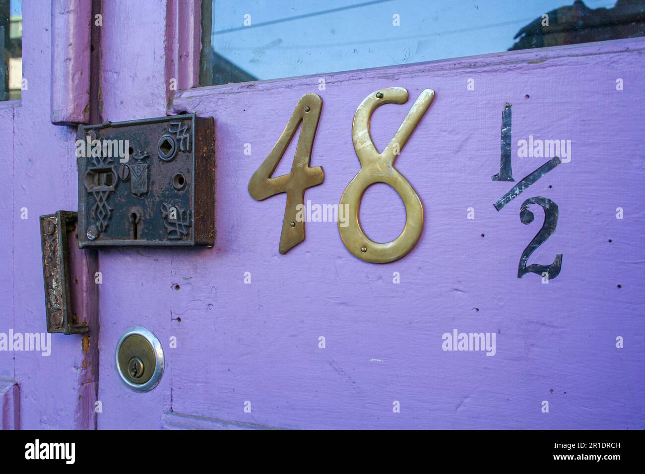 Lavender purple door with glass and number 48 and a half and an old lock. Found in Eureka Springs, Arkansas. Stock Photo